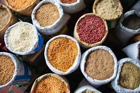 Farmers and traders at Jhunjhunu grain mandi with sacks of mustard and chana