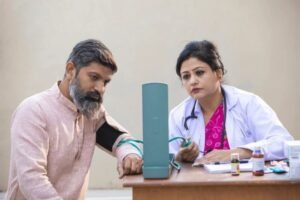 Health worker drawing blood from patient at free dengue screening camp in Jhunjhunu