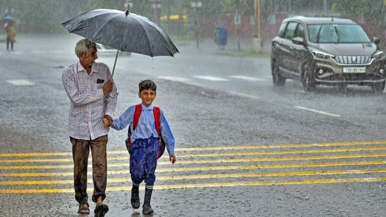 Traffic volunteer guiding students across road near Jhunjhunu school during safety drive