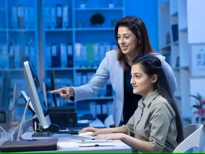 Postal worker helping resident open digital savings account at Jhunjhunu post office kiosk